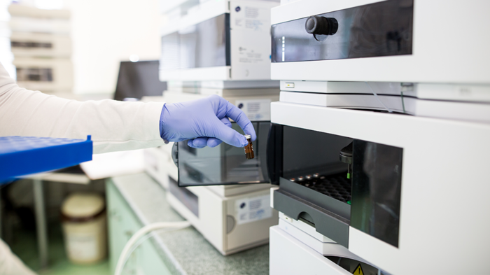 Flasks with liquids in a lab, pharmaceutical industry factory and production laboratory, chemistry concep